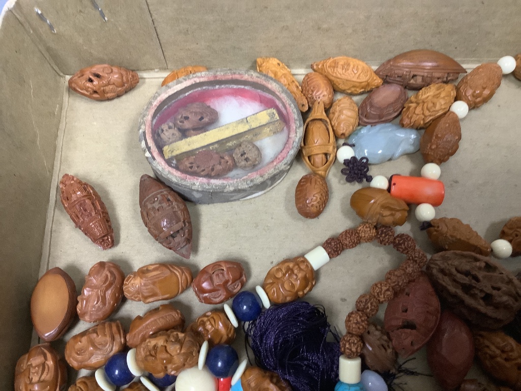 A quantity of Chinese peach stone and nut carvings